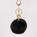 Detail of black faux fur pompom keychain with gold seashell pendant and white pearl - Black
