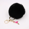 Detail of black faux fur pompom keychain with golden metal ring and pink flamingo charm - Black
