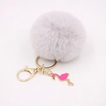 Detail of grey faux fur pom pom keychain with gold ring and pink enamel flamingo charm - Light Gray
