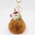Detail of colorful glitter unicorn charm with brown faux fur pom pom and gold lobster clasp - Coffee