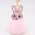 Close-up of pink bunny plush keychain with soft faux fur ball and golden metal hook clasp - Light Pink