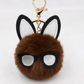 Detailed close-up of brown plush bunny keychain with rabbit ears and black glasses frame - Brown