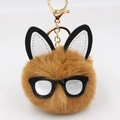 Close-up of brown plush bunny keychain with round glasses and golden metal ring clip - Coffee