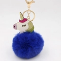 Detailed close-up of dark blue faux fur pompom with a glitter unicorn charm and gold clasp - Sapphire Blue