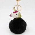 Detail of colorful sequined unicorn head with black plush ball on a golden keyring - Black