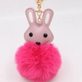 Detail of pink faux fur bunny keychain with PU leather head and golden metal clasp - Rose Red