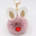 Close-up of pink fluffy pompom rabbit keychain with gold glitter ears and metal spring clasp - Bunny Ear Pom Pom Keychain / Dust Rose