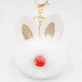 Detail of white fluffy rabbit fur pompom keychain with golden glitter ears and red nose - Bunny Ear Pom Pom Keychain / White