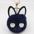 Detail of navy blue faux fur pompom keychain with rabbit ears and black glasses frame - Navy Blue