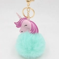 Detailed macro view of mint green plush fur ball and pink leather unicorn keychain charm - Gold Keychain / Mint Green