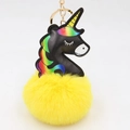 Detail view of unicorn keychain featuring black PU leather head and fluffy yellow pompom - Yellow