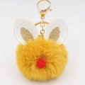 Detail of yellow fluffy pompom keychain with white bunny ears and golden sequins - Bunny Ear Pom Pom Keychain / Orange