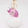 Close-up of pink faux leather unicorn pendant with large white fluffy pom-pom and gold clasp - Gold Keychain / White