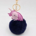 Close-up of fluffy blue unicorn keychain with pink leather head and golden metal hook - Gold Keychain / Navy Blue