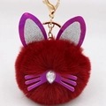 Detail of plush cat ear keychain with purple sequins and a crystal teardrop stone - Burgundy