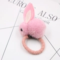 Detail of pink plush bunny ear hair tie with soft pompom and elastic textured band - Pink Hair Tie