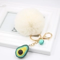 Detail of avocado plush keychain with fluffy white faux fur ball and gold metal clasp - Avocado Keychain / Off-white