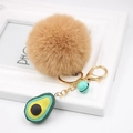Detail of soft brown faux fur pom pom keychain with avocado charm and golden bell - Avocado Keychain / Khaki