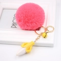 Detail of rose pink pompom keychain with gold lobster clasp and mini banana charm - Watermelon red