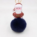 Dettaglio di un ciondolo Babbo Natale in pelle PU con pompon in ecopelliccia blu scuro - Portachiavi d'Oro / Blu Notte