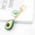 Detail von Avocado Harz Schlüsselanhänger mit goldenem Ring und blauer Glocke - Avocado