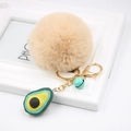 Detail of avocado plush keychain with khaki fur ball and green resin charm on golden clasp - Avocado Keychain / Nude