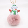 Close-up of pink faux fur snowman keychain with green scarf and gold metal ring - Dusty Pink