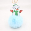 Close-up of fluffy blue snowman pompom keychain with green hat and gold ring - Light Blue