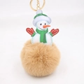 Detailed close-up of Christmas snowman plush keychain with brown faux fur pom pom ball - Khaki