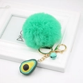Close-up of a plush avocado keychain with mint green pompom and gold spring buckle - Avocado Keychain / Grass Green
