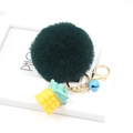 Detail of dark green pompom keychain with yellow resin pineapple and blue bell - Dark Green