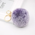 Faux fur pompom keychain in gradient purple with gold lobster clasp on white background - Two-tone Purple