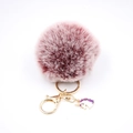Detail showing plush dusty pink pompom with gold unicorn charm and lobster clasp - Small Unicorn Keychain / Dual-color Red