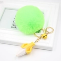Macro view of fluorescent green pompom keychain with yellow resin banana pendant and gold bell - Fluorescent Green