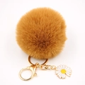Détail d'un porte-clés marguerite en peluche marron avec fermoir mousqueton doré et anneau - Café