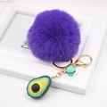 Detailed view of purple plush ball keychain with avocado resin pendant and golden bell - Avocado Keychain / Dark Purple