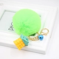 Detail of neon green faux fur pompom keychain with golden pineapple and blue bell - Fluorescent Green