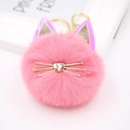 Macro view of pink faux fur cat pompom keychain with golden metal heart nose and whiskers - Deep Pink