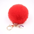 Detailed view of red plush pompom keychain with golden clasp and unicorn charm - Small Unicorn Keychain / Red