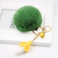 Detail of creative green fluffy pompom keychain with banana charm and golden metal clip - Army Green