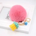 Pink fluffy ball keychain with yellow pineapple charm and blue bell on golden ring - Deep Pink