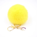 Detail of yellow plush pompom keychain with golden lobster clasp and unicorn charm - Small Unicorn Keychain / Yellow