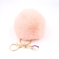 Detail of pink faux fur pompom keychain with golden lobster clasp and unicorn charm - Small Unicorn Keychain / Pink