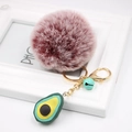Detail of pink faux fur pom pom keychain with a 3D avocado charm and gold lobster clasp - Avocado Keychain / Dual-color Red
