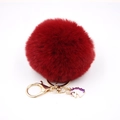 Detail of burgundy faux rabbit fur pom pom keychain with a gold unicorn charm and clasp - Small Unicorn Keychain / Burgundy