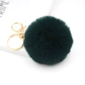 Close-up of dark green faux rabbit fur pom pom with polished gold keychain and spring clasp - Dark Green