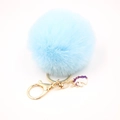 Detail of light blue faux fur pompom keychain with golden lobster clasp and unicorn charm - Small Unicorn Keychain / Light Blue