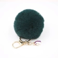 Detail of dark green pompom keychain with gold hardware and enamel unicorn charm - Small Unicorn Keychain / Dark Green