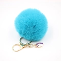 Detail of light blue fluffy pom pom keychain with golden hardware and unicorn charm - Small Unicorn Keychain / Lake Blue