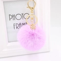 Detail of light purple faux fur keychain with a gold snowflake pendant and clasp - Taro Purple